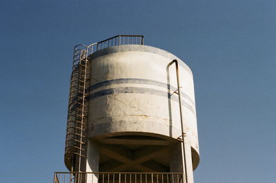 Low angle view of water tower against clear sky