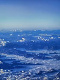 Aerial view of majestic mountains against blue sky