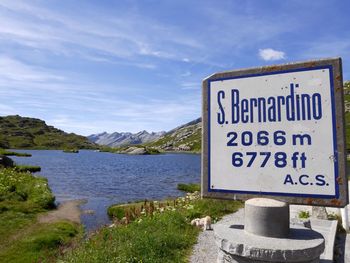 Low angle view of signboard on beach against clear sky