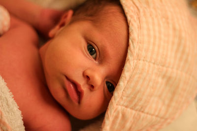 Close-up portrait of cute baby lying