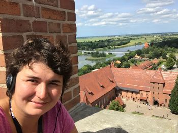 Portrait of smiling woman against building