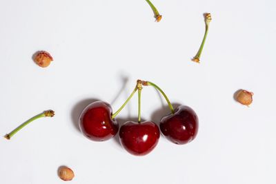 Close-up of cherries over white background