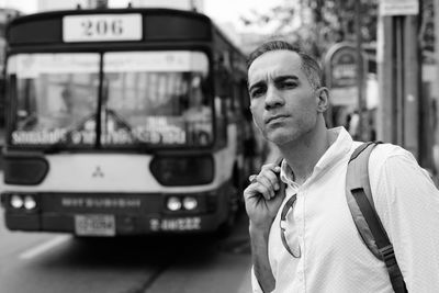 Portrait of man standing at bus stop