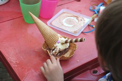 High angle view of person eating ice cream on table