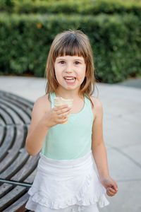 Portrait of a smiling girl standing outdoors