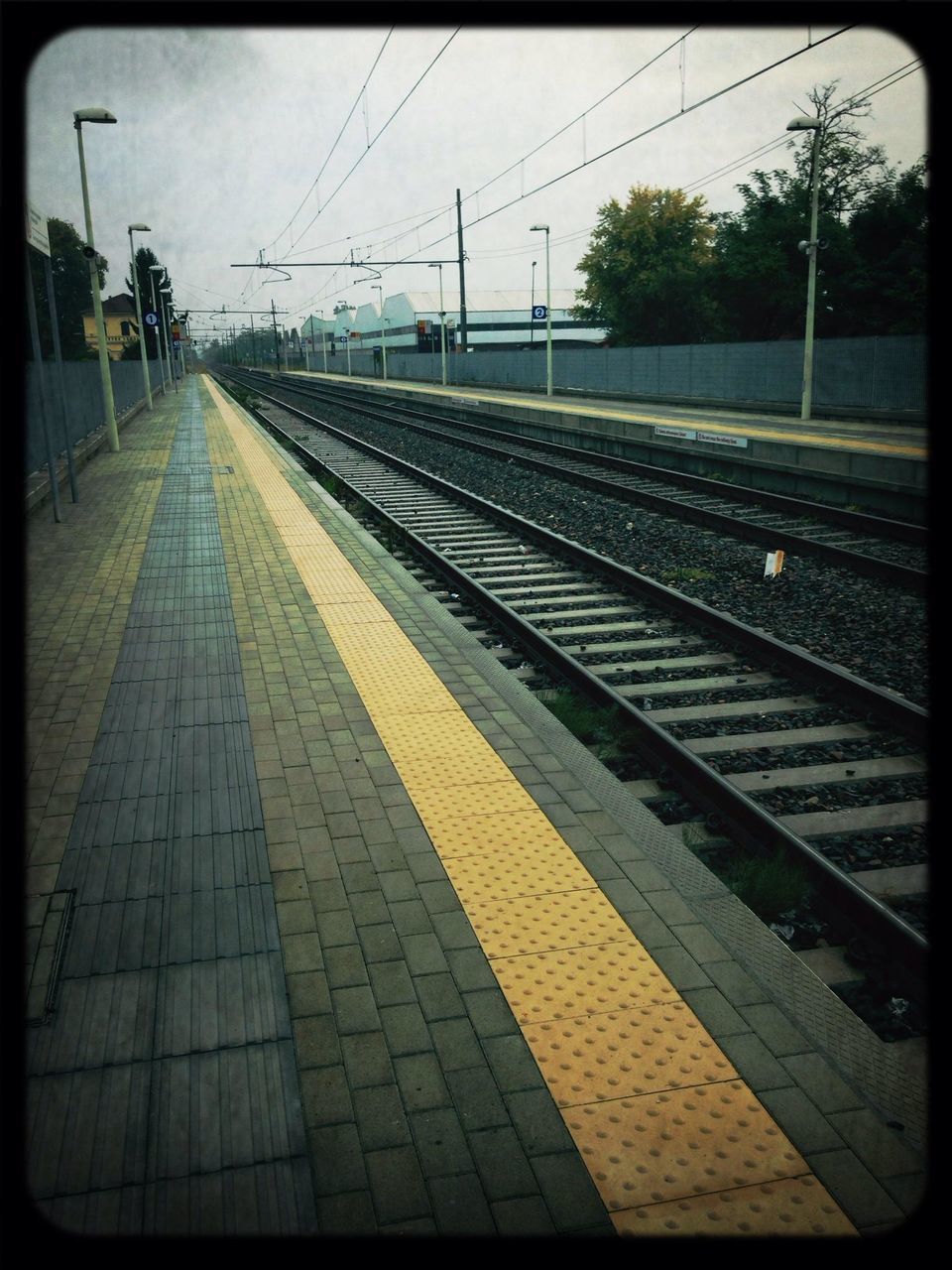 railroad track, transportation, rail transportation, public transportation, railroad station platform, railroad station, power line, diminishing perspective, the way forward, railway track, sky, vanishing point, train - vehicle, electricity pylon, travel, mode of transport, connection, transfer print, train, auto post production filter