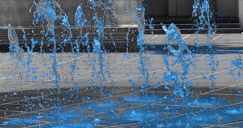 View of water splashing on blue sky