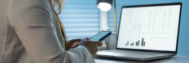 Midsection of woman using mobile phone