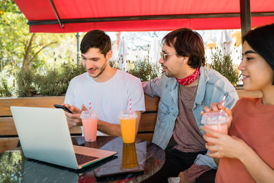 Friends sitting on table at home