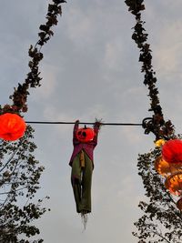 Low angle view of red lanterns hanging against sky