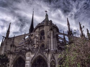 Low angle view of church against cloudy sky