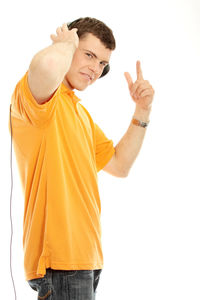 Portrait of young man standing against white background