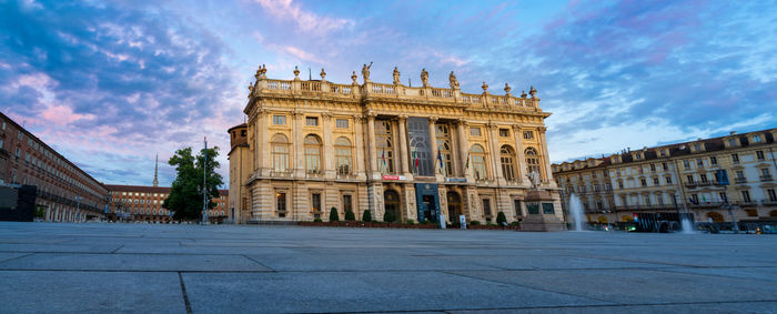 Facade of building in city against sky