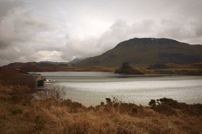 Scenic view of lake and mountains against sky