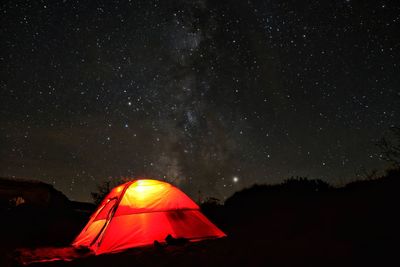 Tent on field against sky at night