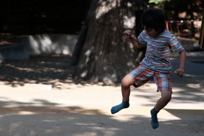 Full length of boy jumping at playground