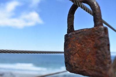 Close-up of rusty metal against sky