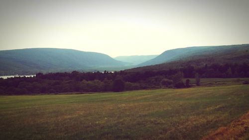 Scenic view of field and mountains against sky