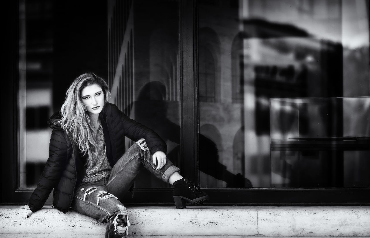 WOMAN SITTING IN THE DARK ROOM