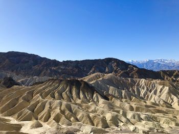 Scenic view of mountains against clear blue sky