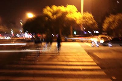 Blurred motion of people on street at night