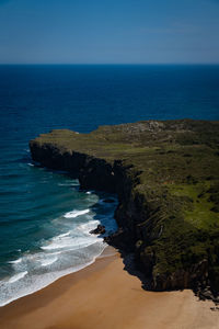 Scenic view of sea against clear blue sky