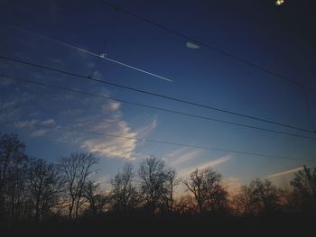 Low angle view of silhouette trees against sky at sunset