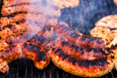 High angle view of meat on barbecue grill