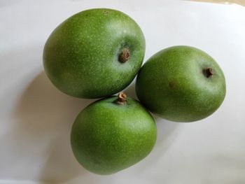 High angle view of apples on green table