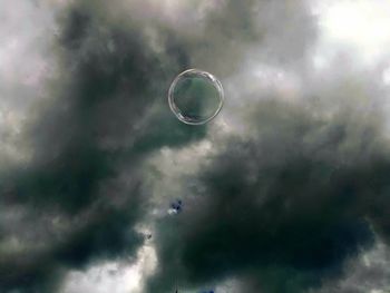 Close-up of bubbles against moon in sky