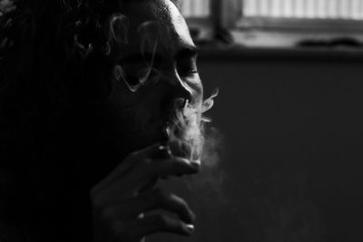 Close-up portrait of man smoking cigarette