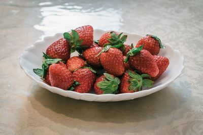 High angle view of strawberries in bowl on table