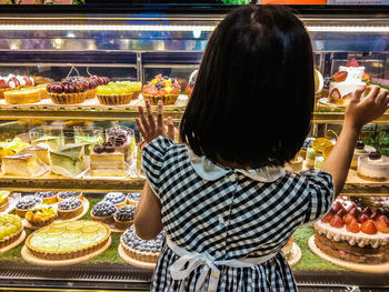 Rear view of woman looking at store