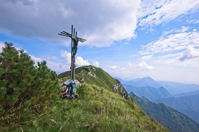 Traditional windmill on mountain against sky