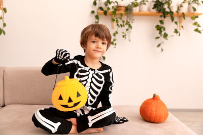 Portrait of boy with pumpkin