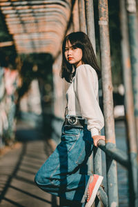 Portrait of young woman standing outdoors