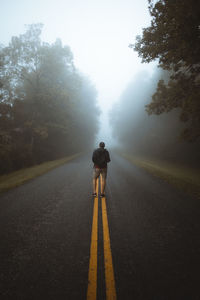 Rear view of man on road