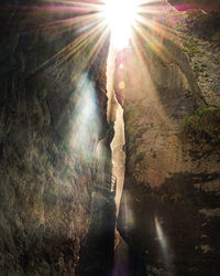 Sunlight streaming through rocks