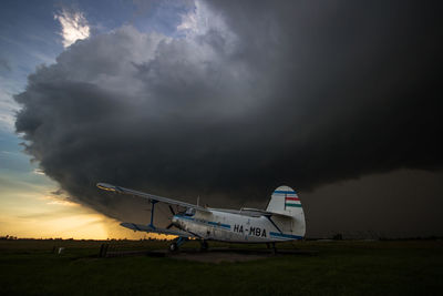 Airplane on runway against sky