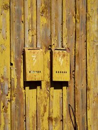 Mailboxes on old yellow wall 