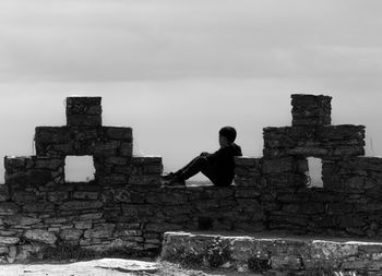 Full length of man by old building against sky