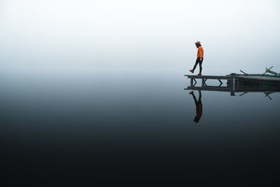 Low angle view of man standing against clear sky