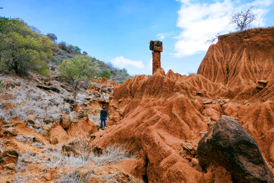 A hiker amidst rock formations at ol jogi canyons in nanyuki, kenya