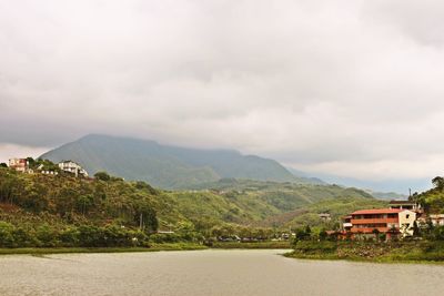 Scenic view of mountains against cloudy sky