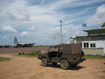 Vintage car on land against sky