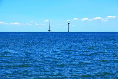 Scenic view of sea against blue sky