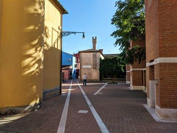 Street amidst buildings against sky in city