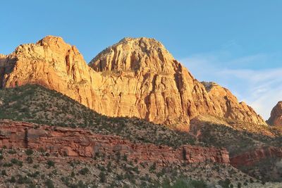 Low angle view of rocky mountain against sky