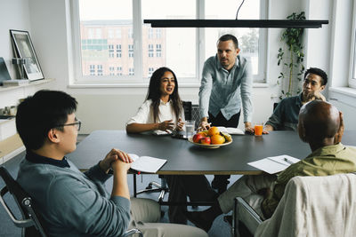 Business colleagues planning while sitting at desk during meeting at office