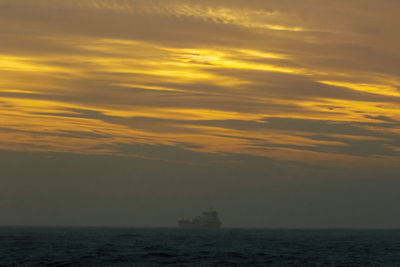 Scenic view of sea against orange sky